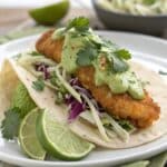 Crispy Fish Taco topped with green avocado sauce